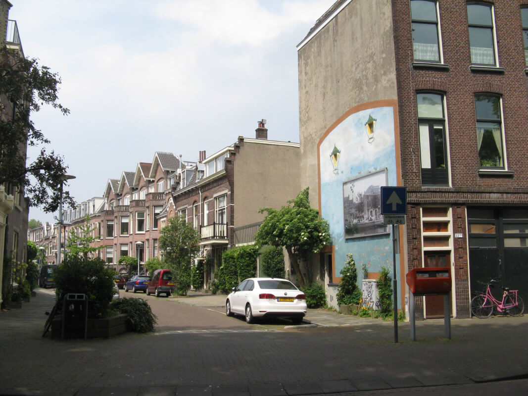 De Bellamystraat. Het bovenhuis Bellamystraat 11bis is onder het puntdak links van het rossige puntdak. Het raam met een rieten stoel ervoor was de kamer van Opoe. Foto: Dik Binnendijk (2016)
