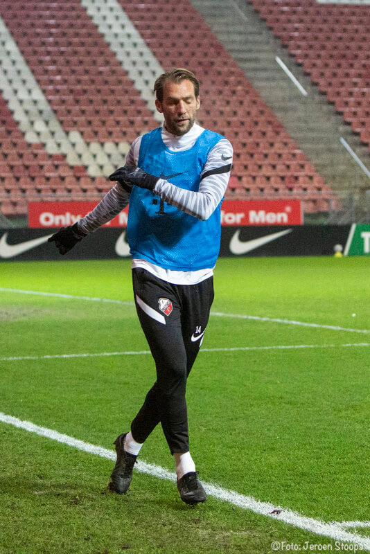 Janssen alleen langs het veld tijdens het warmlopen tijdens de tweede helft.