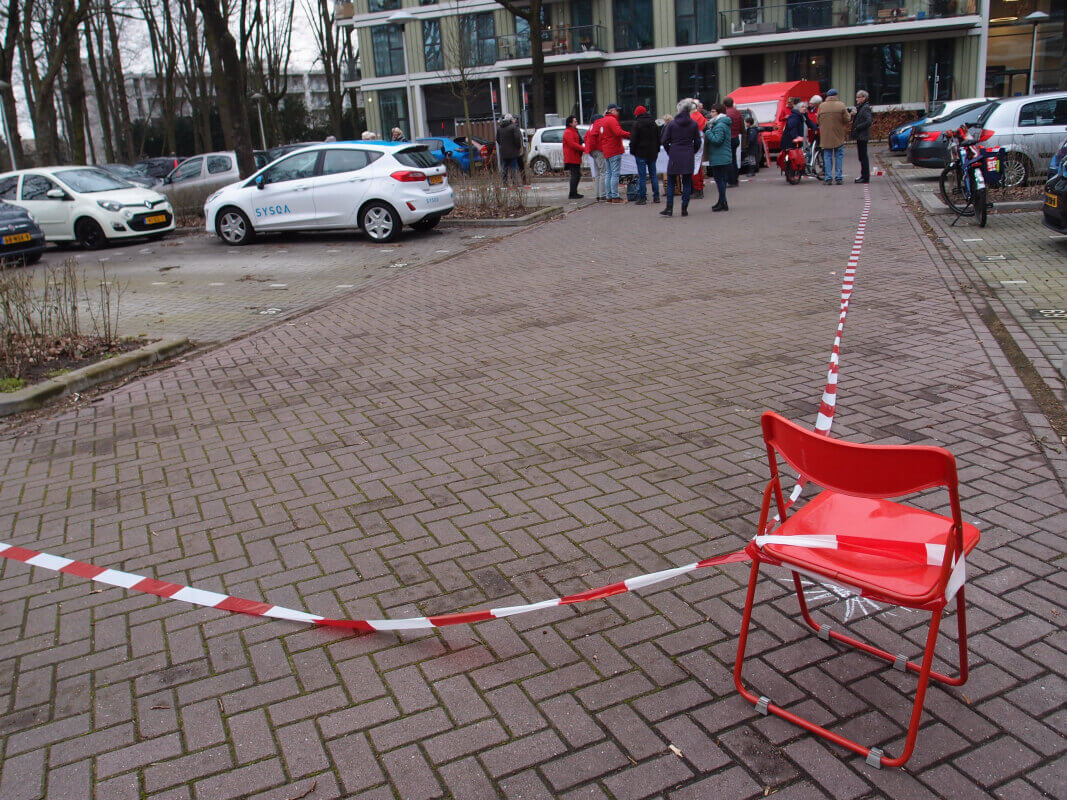 Met rood-witte linten geven buurtbewoners aan hoe groot het geplande appartementencomplex zou worden . Foto: Louis Engelman