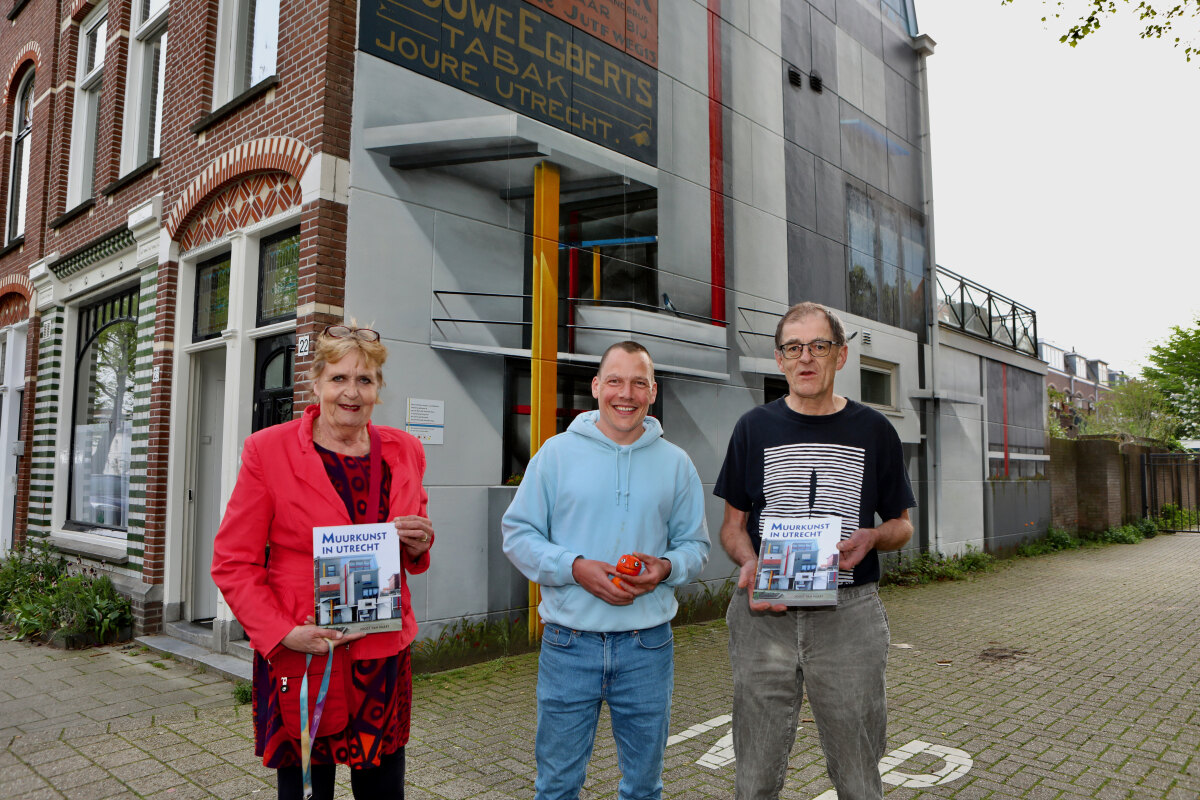 Margreet Boekhout-Abelsma, Jan is de Man en Joost van Waert met het boek voor het kunstwerk Rietveldhuis 2.0 aan de Jutfaseweg. Foto: Ton van den Berg
