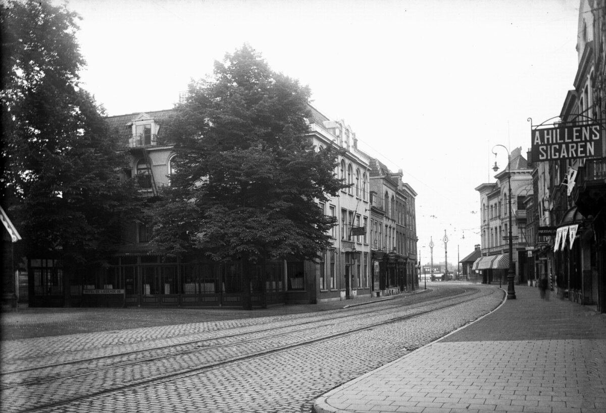 Een vroege zondagmorgen. Er is totaal geen verkeer en alleen rechts zie je een 'bewogen' voetganger. Het zijn de laatste jaren van het bestaan van “De Liggende Os”. Geheel links zie je nog net een hoekje van een houten gebouw. Dit is het secretariaatsgebouw van de Jaarbeurs, hetgeen betekent dat de foto in 		1918 tot 1920 gemaakt kan zijn.