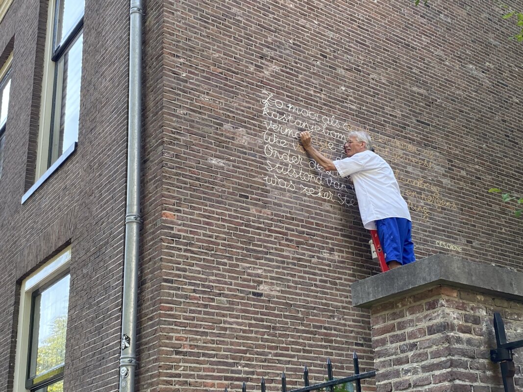 Schilder Jos Peeters aan het werk op de Nieuwegracht. Foto: JT